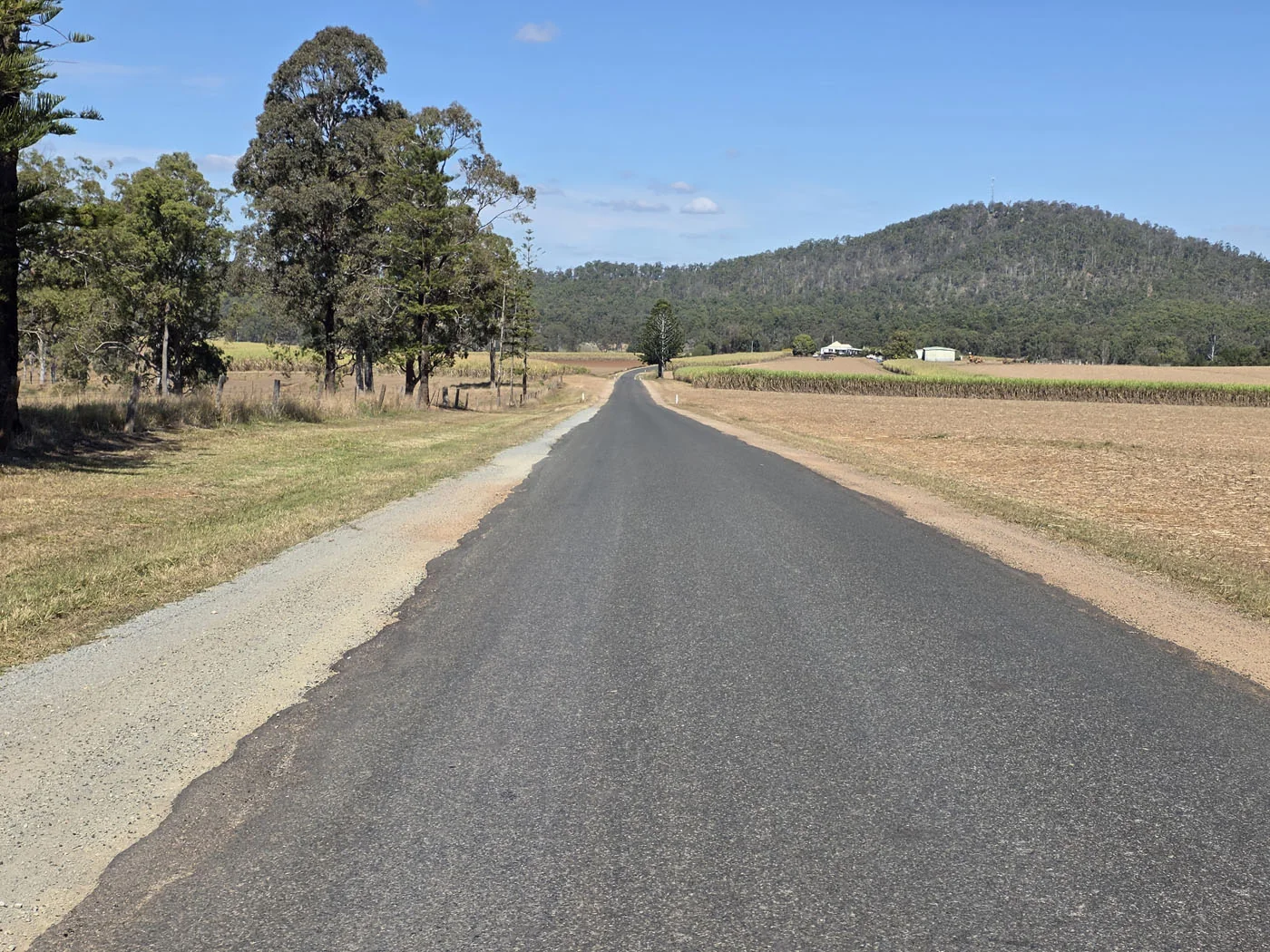 Quiet rural road near Bauple with hills and open country
